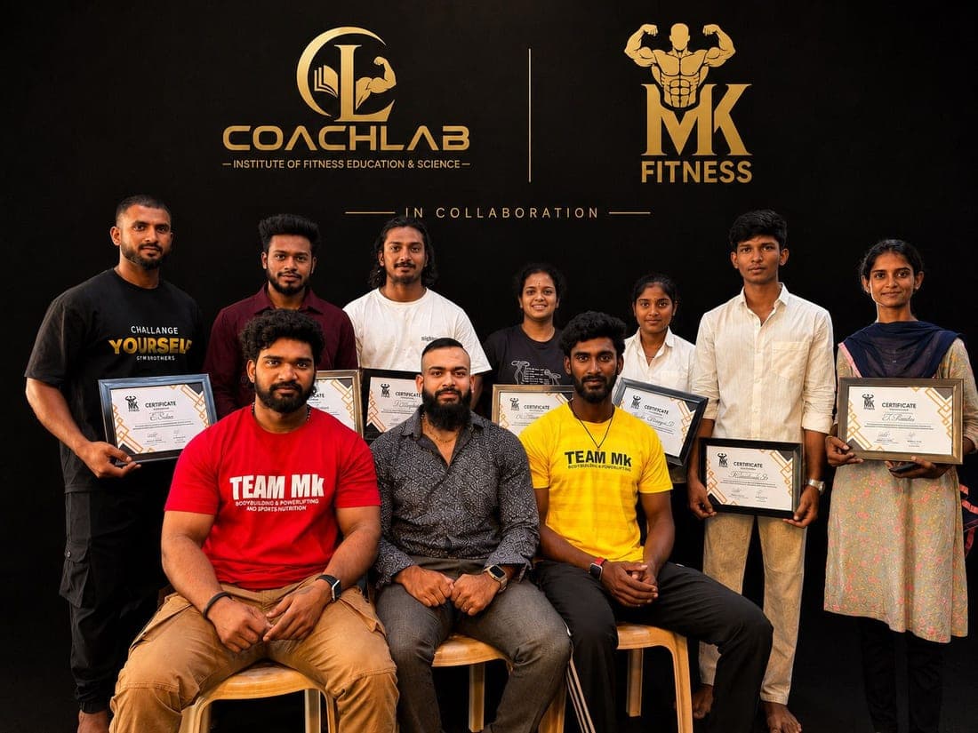 CoachLab students and instructors together at a certificate presentation, photographed in front of the CoachLab backdrop.